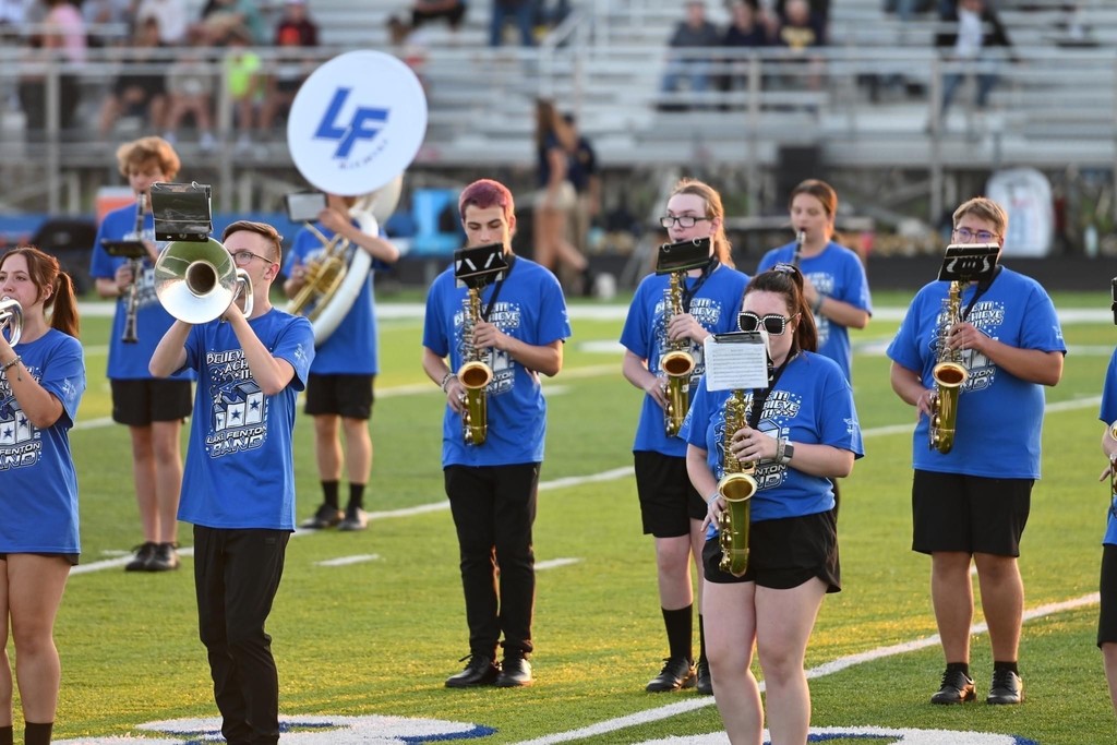 Sax players practicing on the football field
