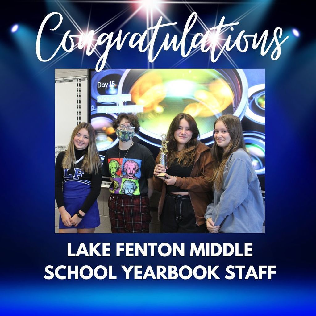Lake Fenton Middle School Yearbook Students holding their Gold Achievement trophy from Jostens