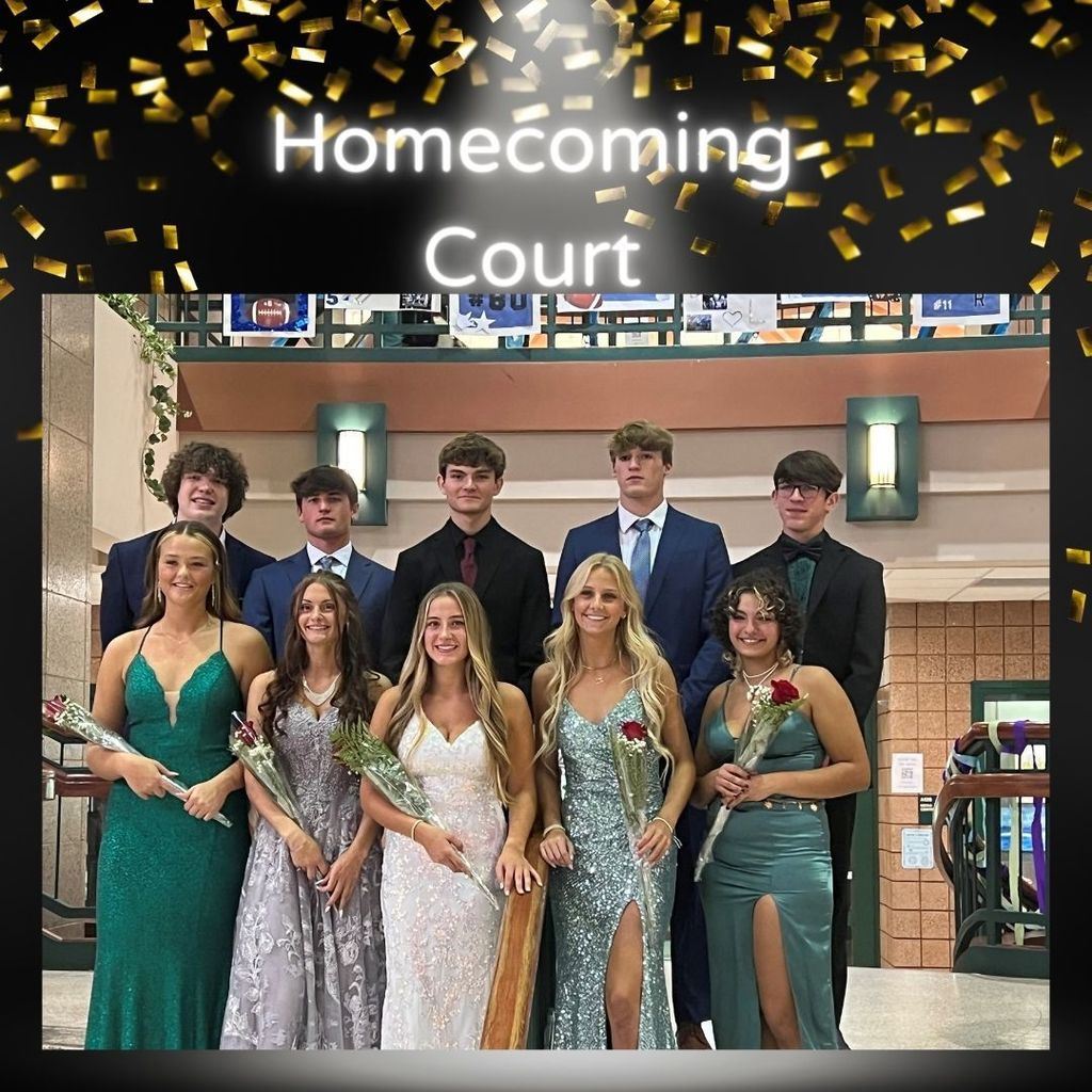 Homecoming court in their formal attire at the high school posing for a picture