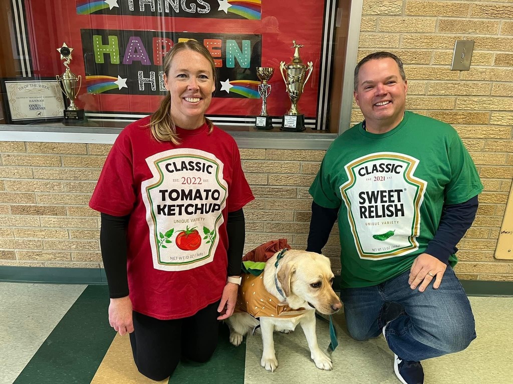 Teachers dressed as ketchup and relish while pup is a hot dog