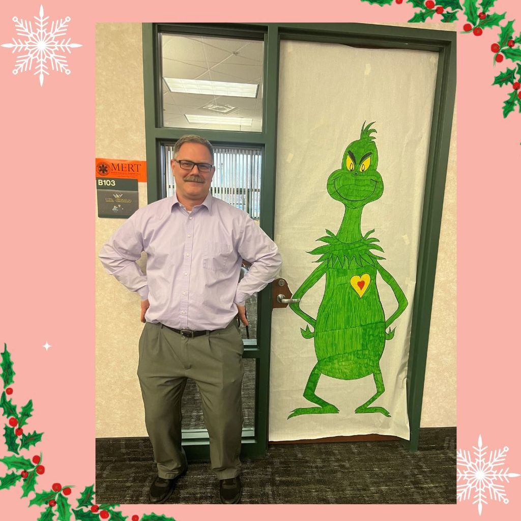 Mr. Cicalo by a decorated door with the Grinch