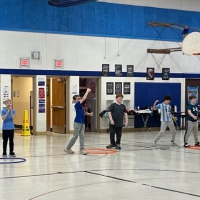 Students learning to throw under hand.