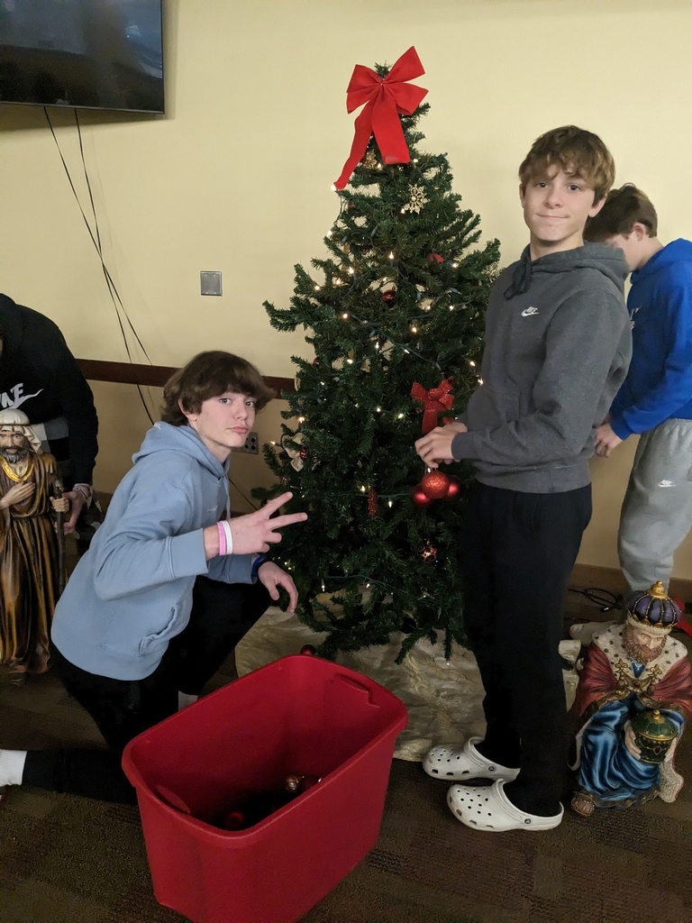 students taking down Christmas decorations