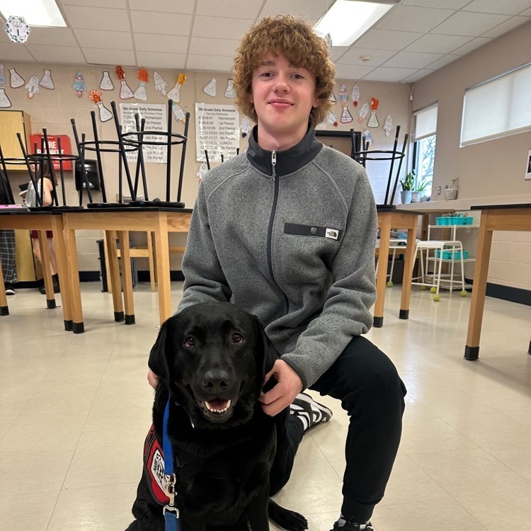 A middle school student with our pup, Charlie.