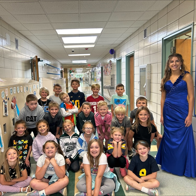girl in blue dress posing with kids