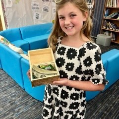 girl holding treasure chest