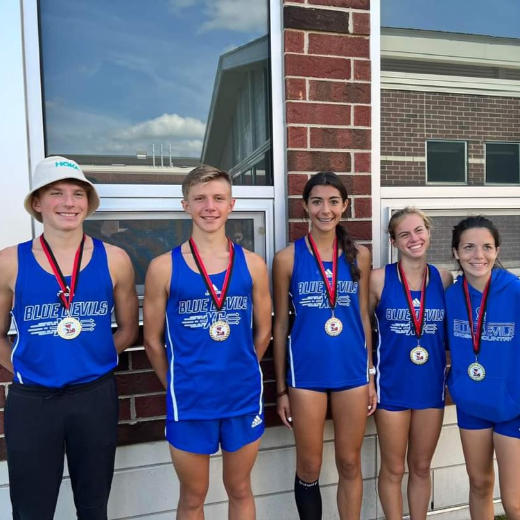 5 cross country runners wearing medals
