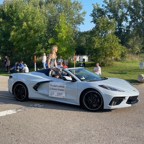 homecoming court riding in silver car