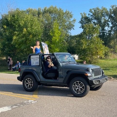 homecoming court riding in grey