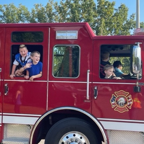 kids riding in fire truck